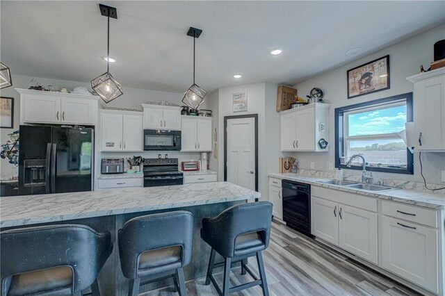 17690 Clayton Ave, Rosemount, MN 55068 - kitchen with black appliances, a sink, white cabinetry, recessed lighting, and decorative light fixtures
