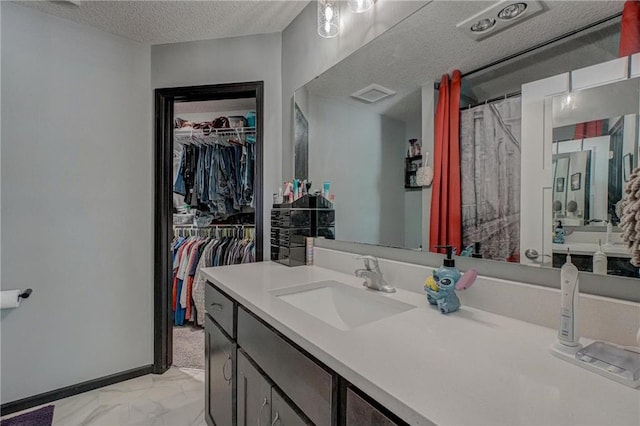 17690 Clayton Ave, Rosemount, MN 55068 - full bath featuring marble finish flooring, vanity, a walk in closet, a textured ceiling, and curtained shower