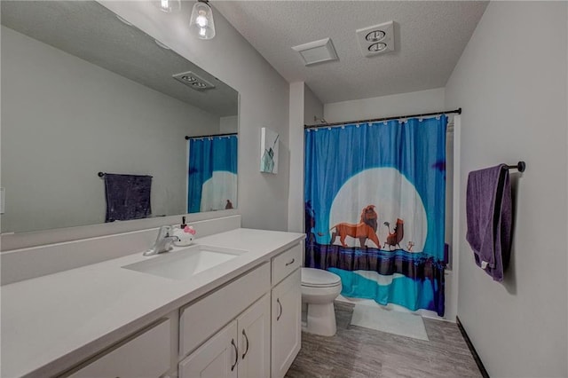 17690 Clayton Ave, Rosemount, MN 55068 - bathroom featuring wood finished floors, a textured ceiling, vanity, toilet, and a shower with shower curtain