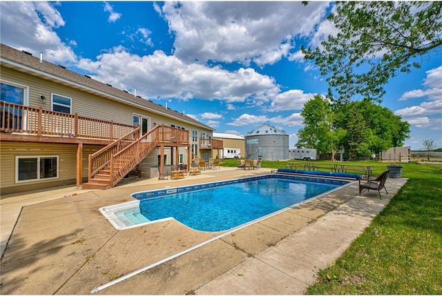 17690 Clayton Ave, Rosemount, MN 55068 - swimming pool with stairway, a wooden deck, a patio, and a lawn