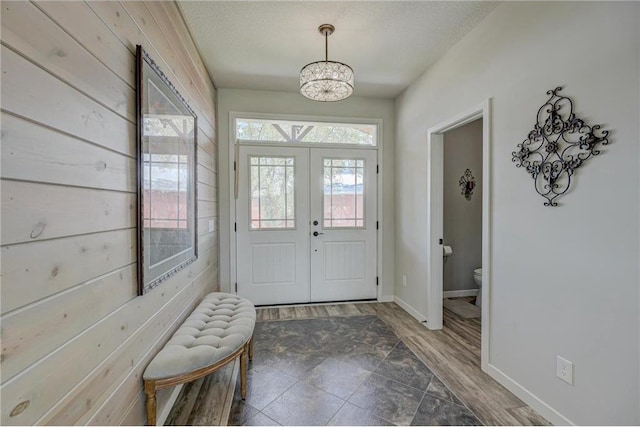 17690 Clayton Ave, Rosemount, MN 55068 - foyer entrance with french doors, wood finished floors, a chandelier, baseboards, and a textured ceiling