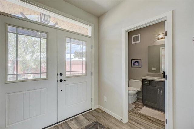 17690 Clayton Ave, Rosemount, MN 55068 - foyer with light wood-type flooring, healthy amount of natural light, baseboards, and french doors