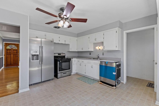 4415 S 5th St, Milwaukee, WI 53207 - kitchen featuring appliances with stainless steel finishes, a ceiling fan, white cabinets, a sink, and baseboards