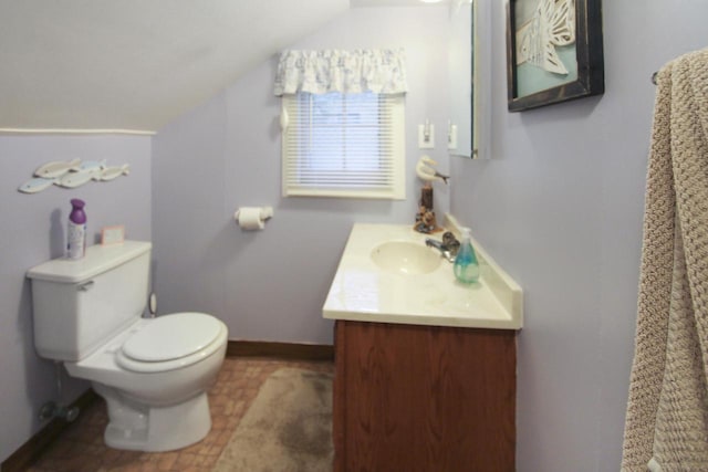N7428 County Road J, Plymouth, WI 53073 - bathroom with lofted ceiling, vanity, toilet, and baseboards
