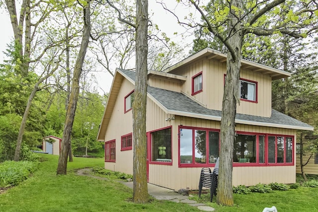 N7428 County Road J, Plymouth, WI 53073 - view of home's exterior featuring a shingled roof and a yard
