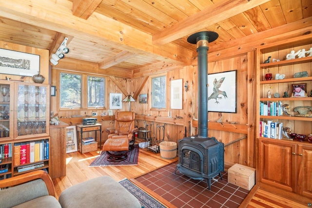 3610 N Shore Rd, La Pointe, WI 54850 - living area with a wood stove, wooden ceiling with exposed beams, wood finished floors, plenty of natural light, and wooden walls