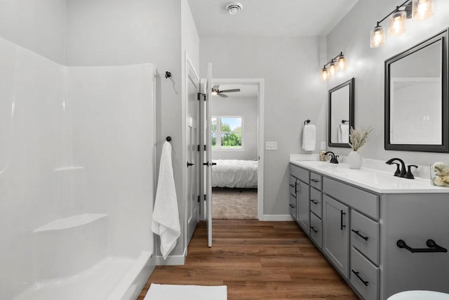 525 S 7th St, Evansville, WI 53536 - bathroom featuring wood finished floors, ceiling fan, connected bathroom, double vanity, and a shower