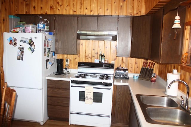 65485 Millicent Point Dr, Iron River, WI 54847 - kitchen featuring white appliances, range hood, a sink, light countertops, and wooden walls