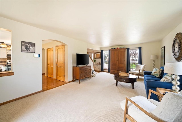 1755 Laura Ln, Port Washington, WI 53074 - living room featuring carpet, arched walkways, and baseboards