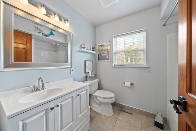 1755 Laura Ln, Port Washington, WI 53074 - bathroom with tile patterned flooring, toilet, vanity, a shower, and baseboards