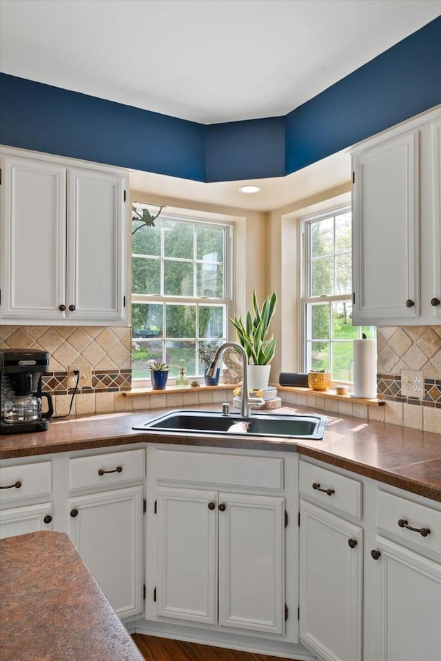 1755 Laura Ln, Port Washington, WI 53074 - kitchen with a sink, white cabinetry, and decorative backsplash