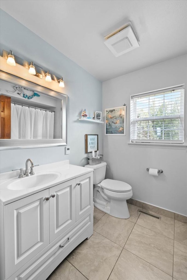 1755 Laura Ln, Port Washington, WI 53074 - bathroom featuring toilet, vanity, and tile patterned flooring