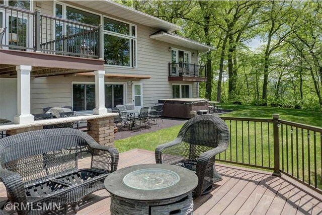 802 Flos Ct, Amery, WI 54001 - deck with a hot tub, an outdoor fire pit, a lawn, a patio, and outdoor dining space