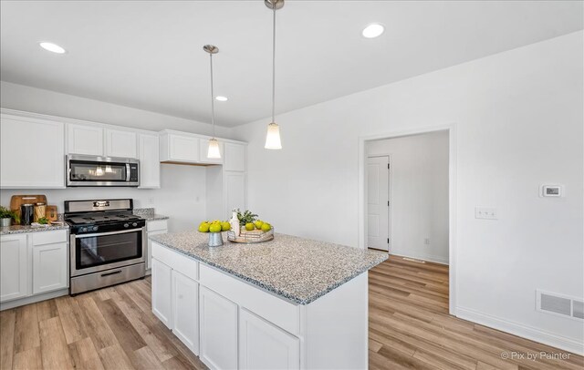 LT45 Lilac Ln, Delavan, WI 53115 - kitchen with stainless steel appliances, light wood finished floors, white cabinets, light stone counters, and recessed lighting