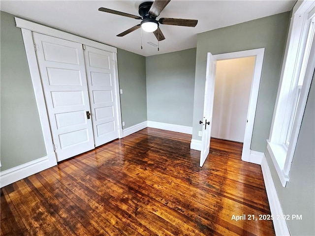23716 Washington St # 1/ # 2, Independence, WI 54747 - unfurnished bedroom featuring hardwood / wood-style floors, baseboards, a closet, and a ceiling fan