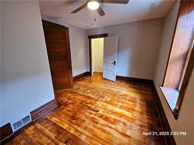 23716 Washington St # 1/ # 2, Independence, WI 54747 - unfurnished bedroom featuring wood finished floors, baseboards, and a ceiling fan