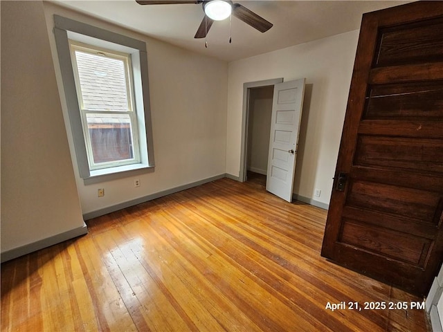 23716 Washington St # 1/ # 2, Independence, WI 54747 - unfurnished bedroom featuring baseboards, light wood-style floors, and ceiling fan