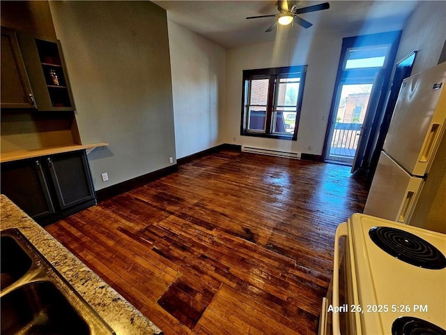 23716 Washington St # 1/ # 2, Independence, WI 54747 - kitchen featuring freestanding refrigerator, white electric stove, a baseboard heating unit, dark wood-style floors, and a ceiling fan