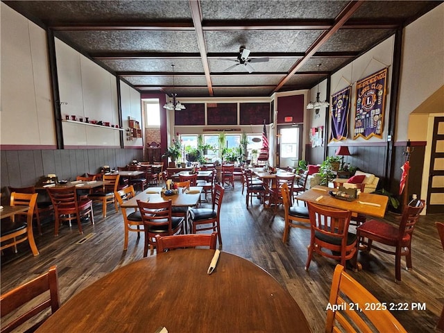 23716 Washington St # 1/ # 2, Independence, WI 54747 - dining space featuring wood-type flooring, a ceiling fan, coffered ceiling, wooden walls, and a wainscoted wall