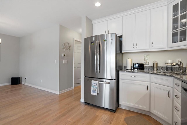 131 Lance Dr Unit 14, Twin Lakes, WI 53181 - kitchen with appliances with stainless steel finishes, a sink, white cabinetry, light wood-style flooring, and baseboards