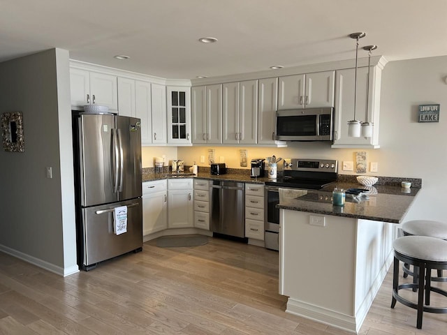 131 Lance Dr Unit 14, Twin Lakes, WI 53181 - kitchen featuring appliances with stainless steel finishes, a peninsula, light wood-style floors, and recessed lighting