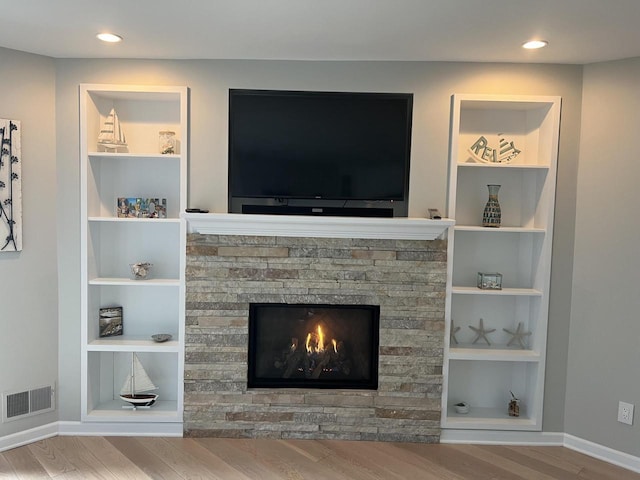 131 Lance Dr Unit 14, Twin Lakes, WI 53181 - detailed view of wood finished floors, baseboards, a fireplace, built in features, and recessed lighting