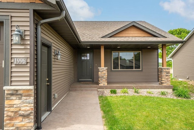 1996 Tucker Trl, Eau Claire, WI 54703 - property entrance with a shingled roof, covered porch, and a yard