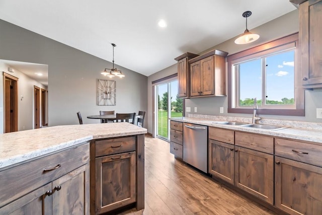 1996 Tucker Trl, Eau Claire, WI 54703 - kitchen with stainless steel dishwasher, a sink, lofted ceiling, light wood-style floors, and decorative light fixtures