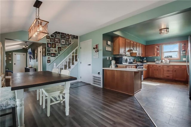 W4505 890th Ave, Baldwin, WI 54002 - kitchen featuring appliances with stainless steel finishes, lofted ceiling, light countertops, decorative light fixtures, and a peninsula