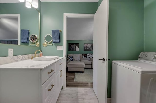 W4505 890th Ave, Baldwin, WI 54002 - bathroom featuring washer / clothes dryer, vanity, and wood finished floors