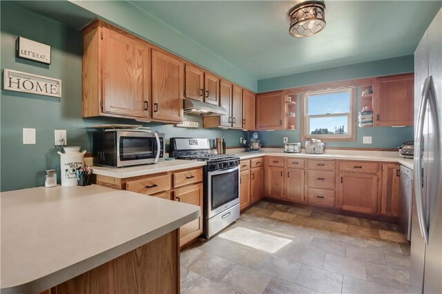 W4505 890th Ave, Baldwin, WI 54002 - kitchen featuring stainless steel appliances, under cabinet range hood, open shelves, light countertops, and stone finish floors