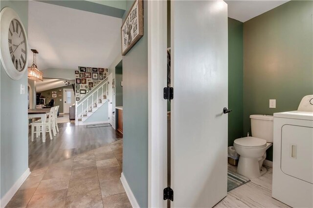 W4505 890th Ave, Baldwin, WI 54002 - bathroom featuring washer / dryer, toilet, baseboards, and lofted ceiling