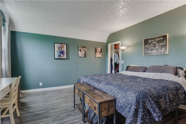 W4505 890th Ave, Baldwin, WI 54002 - bedroom featuring wood finished floors, baseboards, and a walk in closet