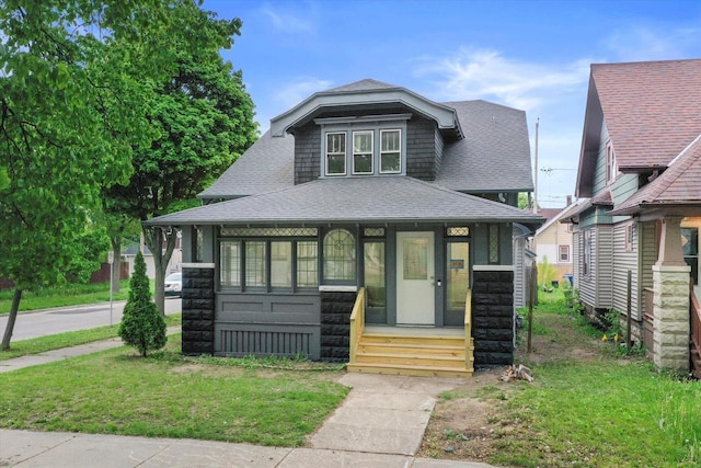 2976 N 40th St, Milwaukee, WI 53210 - view of front of home with a shingled roof, stone siding, and a front lawn