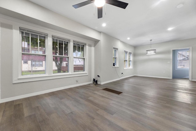 2976 N 40th St, Milwaukee, WI 53210 - unfurnished living room featuring healthy amount of natural light, a ceiling fan, baseboards, dark wood-style flooring, and recessed lighting
