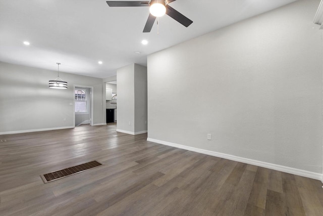 2976 N 40th St, Milwaukee, WI 53210 - unfurnished living room featuring baseboards, ceiling fan, wood finished floors, recessed lighting, and a chandelier