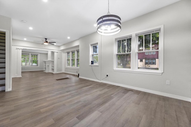 2976 N 40th St, Milwaukee, WI 53210 - unfurnished living room with a ceiling fan, wood finished floors, baseboards, recessed lighting, and a chandelier