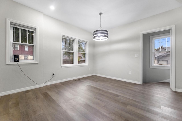 2976 N 40th St, Milwaukee, WI 53210 - unfurnished room featuring plenty of natural light, a chandelier, wood finished floors, and baseboards