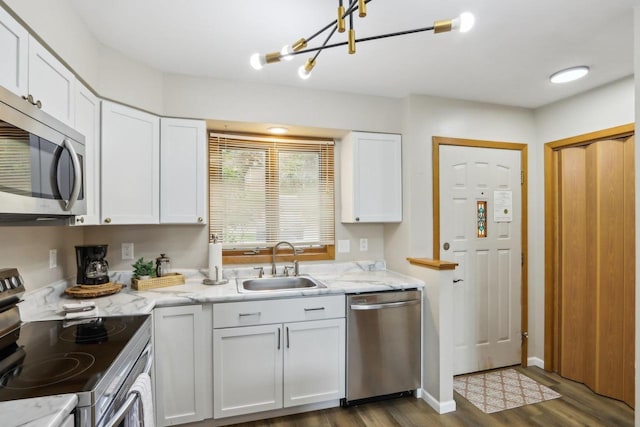 874 Xanadu Rd, Wisconsin Dells, WI 53965 - kitchen with appliances with stainless steel finishes, a sink, dark wood-style floors, and white cabinetry
