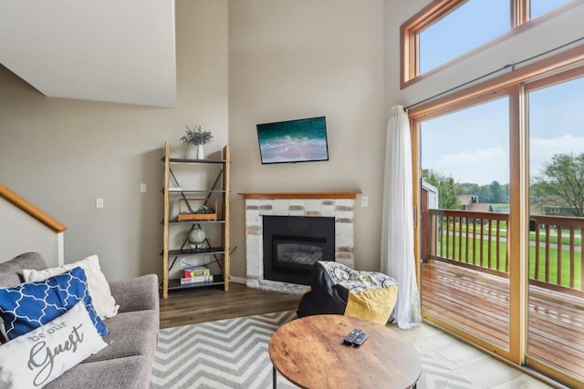 874 Xanadu Rd, Wisconsin Dells, WI 53965 - living room with a tile fireplace, wood finished floors, and a high ceiling