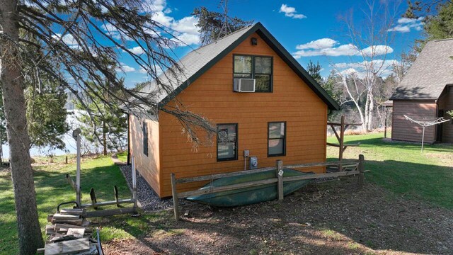 W3789 Villa Bay Dr Unit 7, Tomahawk, WI 54487 - back of property featuring a lawn