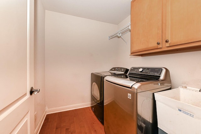 8940 Marie Ct, Mount Pleasant, WI 53406 - laundry room with washing machine and clothes dryer, cabinet space, wood finished floors, and baseboards