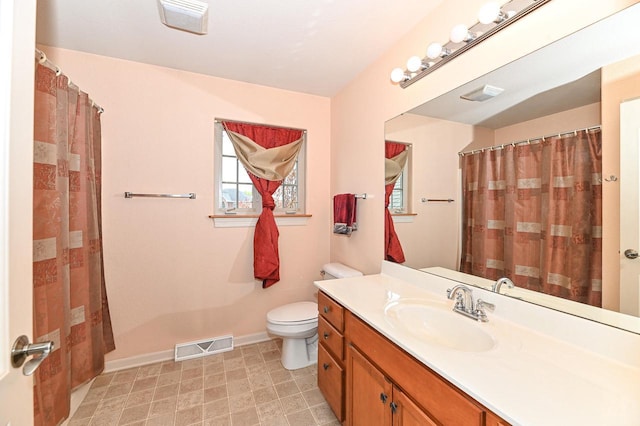 8940 Marie Ct, Mount Pleasant, WI 53406 - full bath featuring toilet, baseboards, vanity, and curtained shower