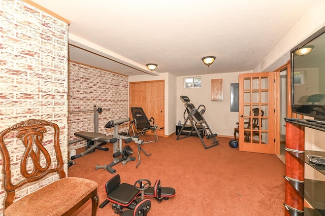8940 Marie Ct, Mount Pleasant, WI 53406 - exercise room featuring carpet floors, brick wall, and baseboards