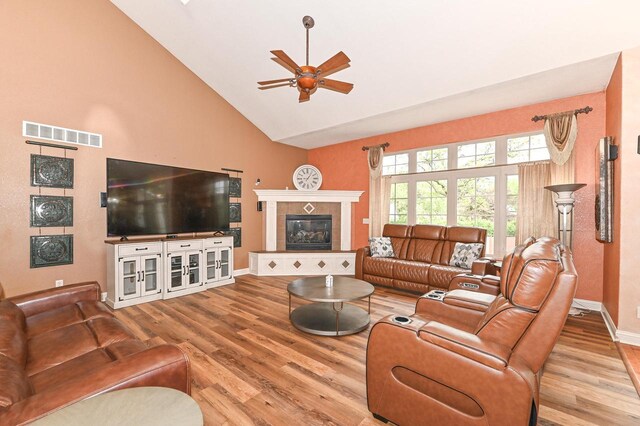 8940 Marie Ct, Mount Pleasant, WI 53406 - living room with ceiling fan, wood finished floors, a tile fireplace, high vaulted ceiling, and baseboards