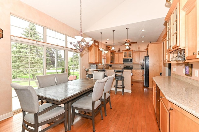 8940 Marie Ct, Mount Pleasant, WI 53406 - dining area with light wood finished floors, a chandelier, a ceiling fan, recessed lighting, and high vaulted ceiling