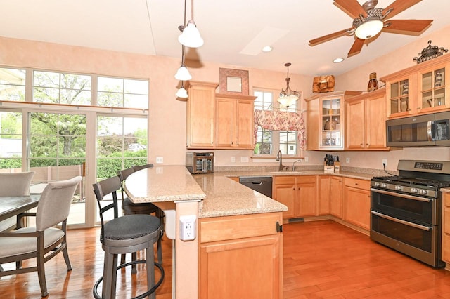 8940 Marie Ct, Mount Pleasant, WI 53406 - kitchen with appliances with stainless steel finishes, a peninsula, light brown cabinets, a sink, and recessed lighting