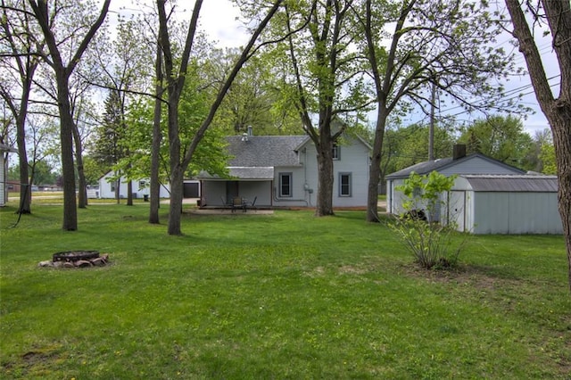 320 E Linden St, Chippewa Falls, WI 54729 - view of grassy yard featuring a fire pit and an outbuilding