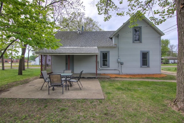 320 E Linden St, Chippewa Falls, WI 54729 - back of house featuring a yard, a patio area, and roof with shingles