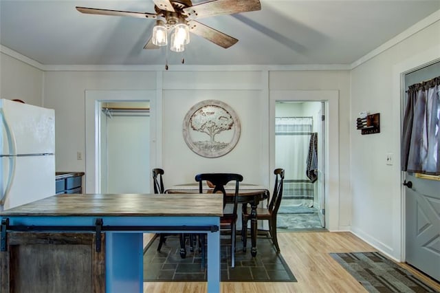 320 E Linden St, Chippewa Falls, WI 54729 - dining space featuring a ceiling fan, light wood-type flooring, baseboards, and crown molding